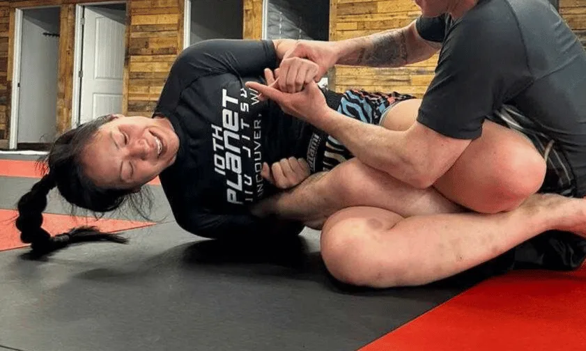 Photo of Reese engaged in a jiu-jitsu leg entanglement